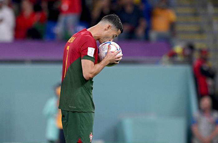 Cristiano Ronaldo pictured kissing the ball before converting a penalty against Ghana to score at his fifth FIFA World Cup for Portugal